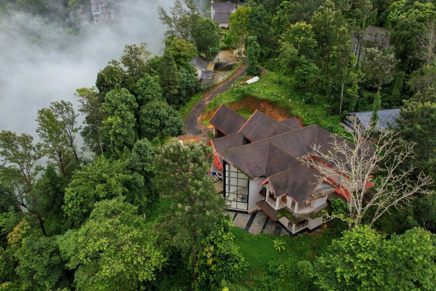 Aerial view of Cliffotel in the Attamala forest, surrounded by mist