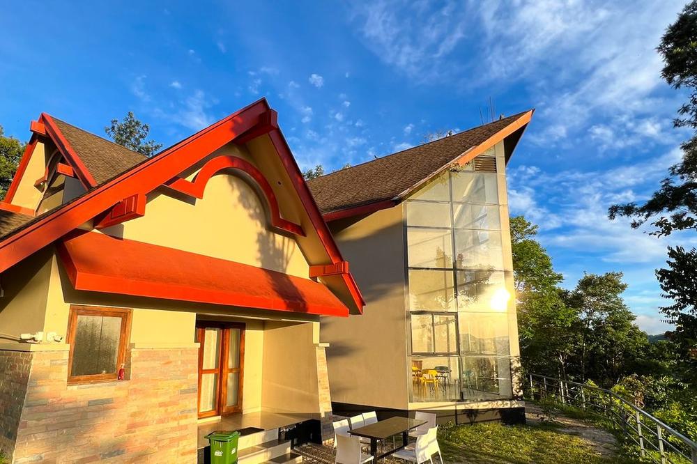 A-frame villa with a glass gable, looking out over the valley